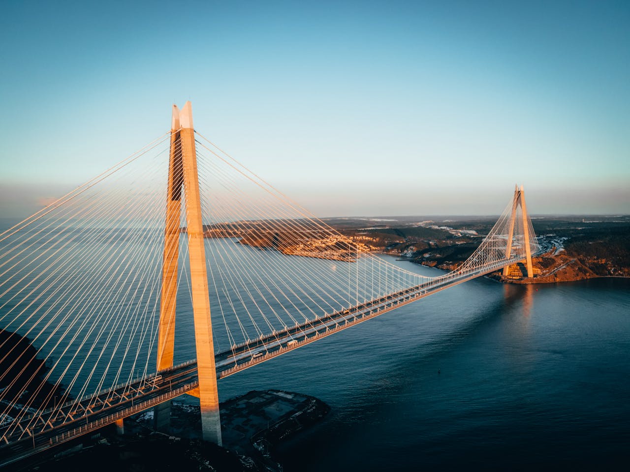Stunning aerial shot of Yavuz Sultan Selim Bridge spanning the Bosphorus Strait at sunset.