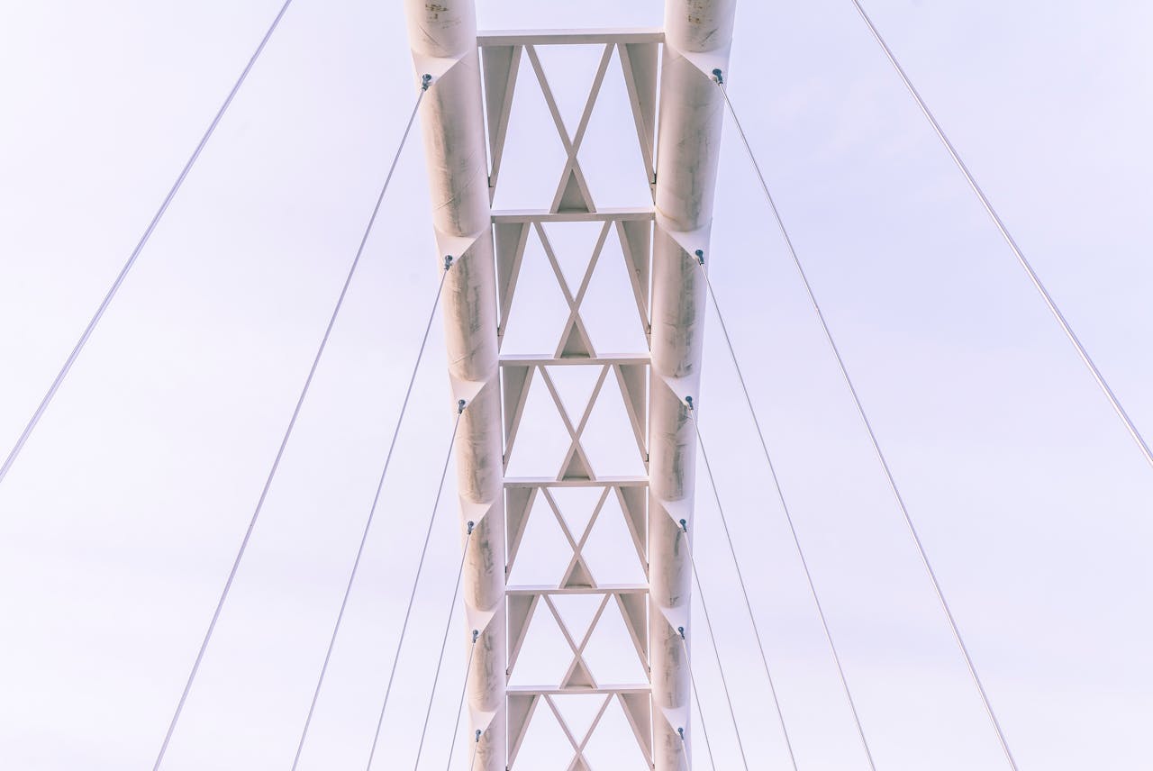 Low angle shot of a modern suspension bridge emphasizing its architectural design and steel structure.